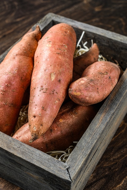 Batata-doce crua na mesa de madeira