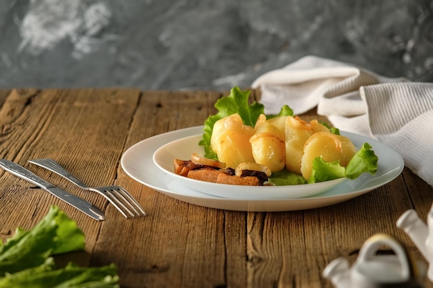 Batatas cozidas com comida caseira e cozinha em uma mesa de madeira utensílios brancos
