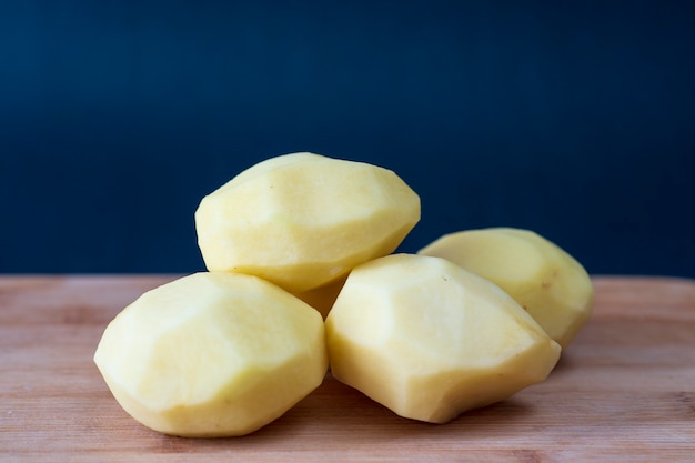 Batatas descascadas à mão na mesa