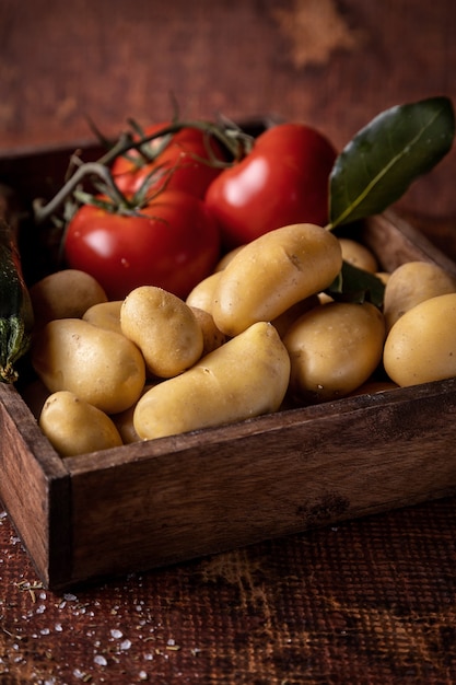 Batatas e tomates em caixa rústica