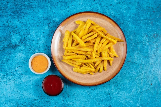 Batatas fritas crocantes ou batatas fritas com molho de maionese e molho de tomate servidas em um prato vista lateral batatas fritas crocantes ou batatas fritas com molho de maionese e molho de tomate servidas em um prato vista lateral