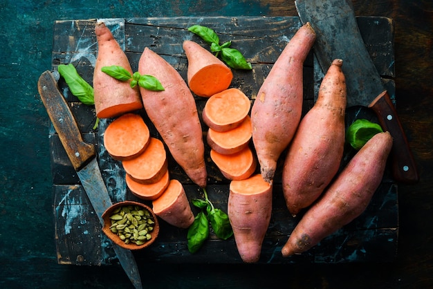 Batatas orgánicas crudas sobre un fondo de madera Comida dietética Vista superior