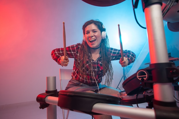 Batería electrónica de música y concepto de hobby mujer baterista en un estudio de grabación