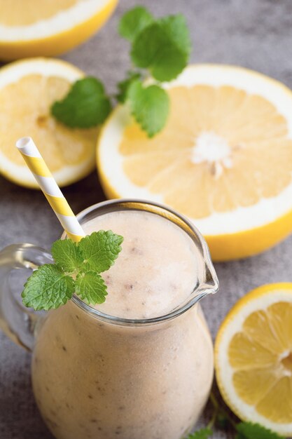 Batido de banana e limão, na mesa cinza.