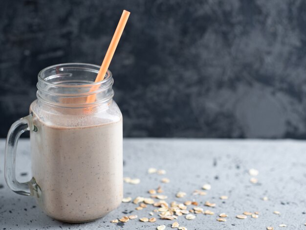 Batido do leite de chocolate com porcas e canela da farinha de aveia. café da manhã saudável