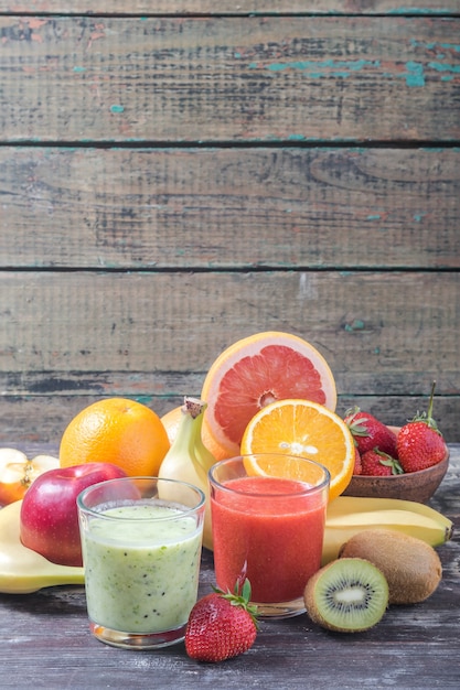 Batido de frutas y bayas, comida sana en tarro sobre mesa de madera rústica