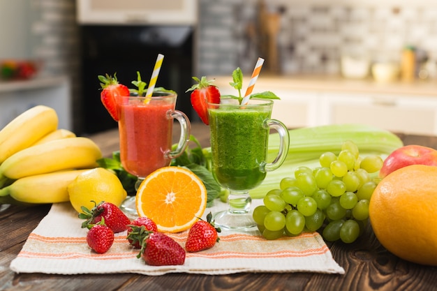 Foto batido de frutas y verduras frescas en la mesa de la cocina en vidrio