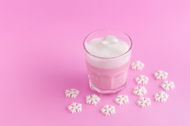 Batido de leche de fresa del vaso sobre fondo rosa