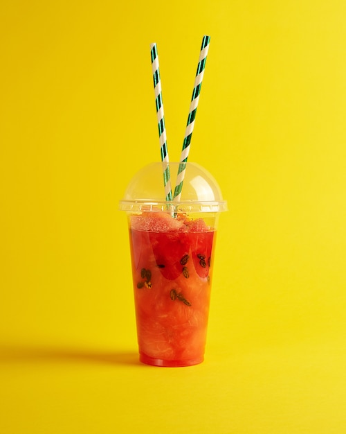 Batido de sandía roja madura en un vaso de plástico