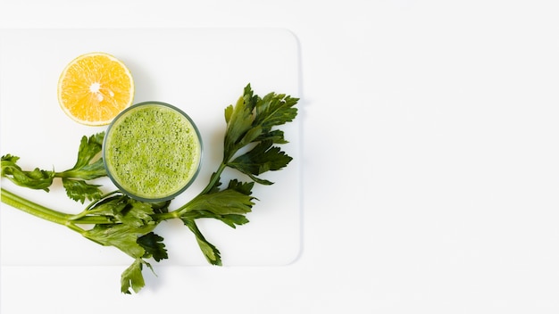 Foto batido verde plano en vaso con limón