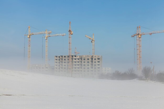 Baukräne auf einer Baustelle im Winter