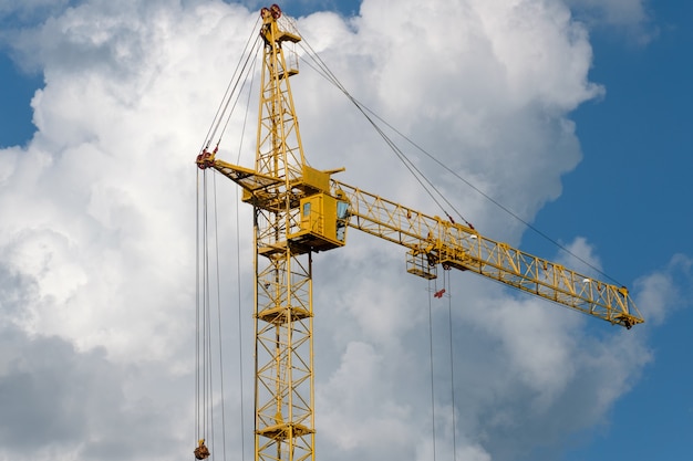 Baukräne und Bauhaus gegen den blauen Himmel