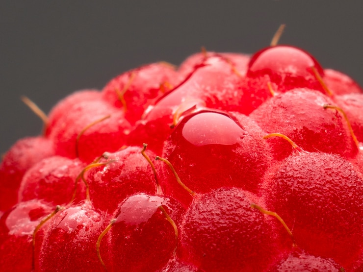 Foto bayas de frambuesa fresca natural macro vitaminas para humanos sobre un fondo oscuro. aislar.