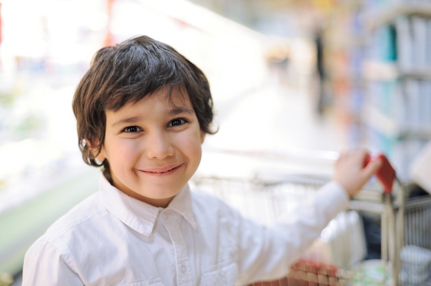 Beautiful smiling kid in supermarket