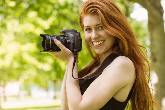 Beautiful woman photographer at park