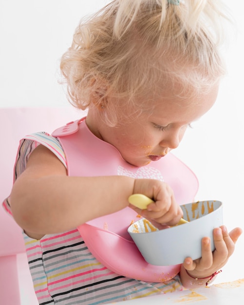 Foto bebê adorável brincando com comida