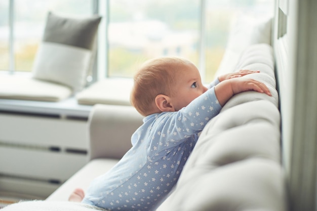 Bebê engatinhando e subindo no sofá em casa