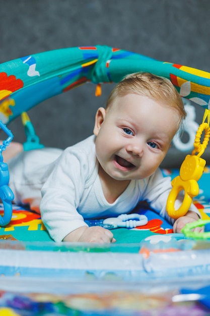 Un bebé está acostado en una alfombra El bebé aprende a sostener su cabeza Desarrollo de un niño recién nacido