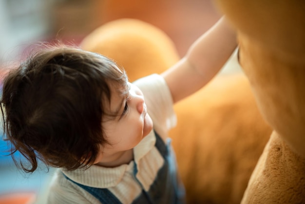 Bebé feliz del niño del hijo que juega en casa apoyando con el padre y la madre de la familia