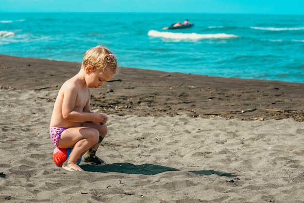 Foto bebé jugando en la playa