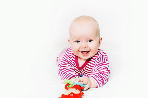 Bebê mais fofo sorridente brincando com brinquedos coloridos criança feliz de 6 meses brincando e descobrindo