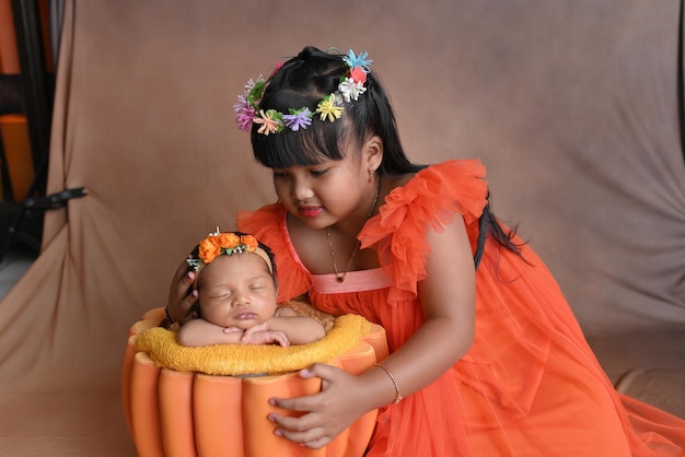 Foto un bebé en una olla de calabaza con su madre.