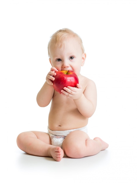 Bebé que come la manzana roja, aislada en blanco