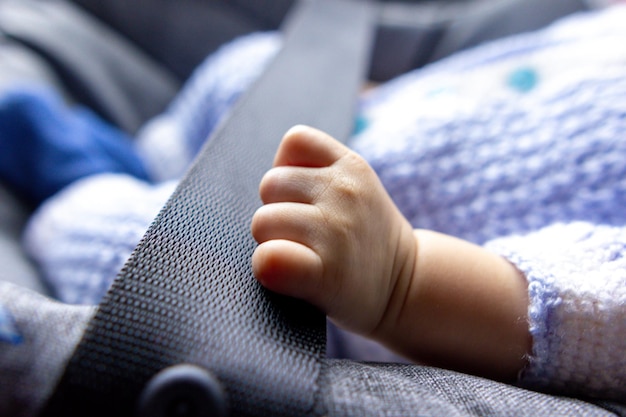 Foto bebé recién nacido puño en un coche