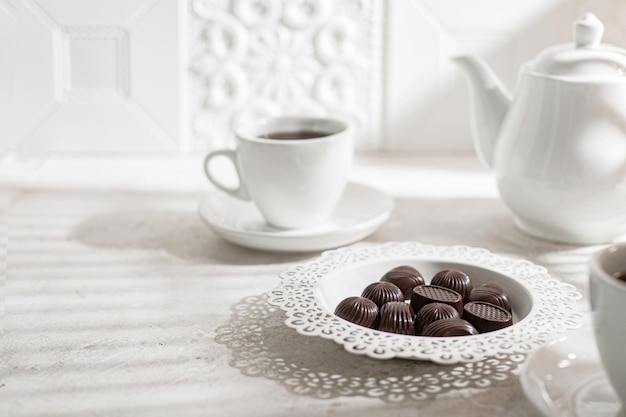 Beber chá. Hora do chá. Bule de chá branco com xícaras e um conjunto de chocolates. café da manhã inglês