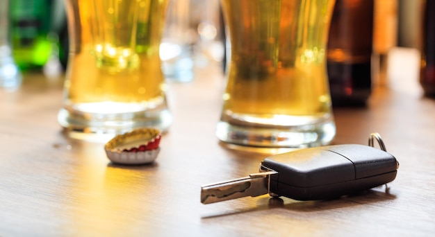 Foto beber y conducir llave del coche en un mostrador de bar de madera