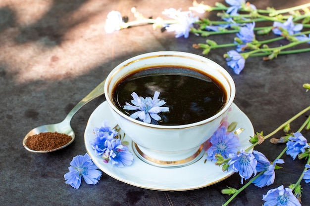 Bebida de achicoria saludable en taza decorada con flores de achicoria Bebida a base de hierbas sustituto del café Enfoque selectivo