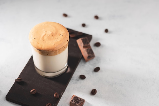 Bebida de café Dalgona batida en un vaso con leche