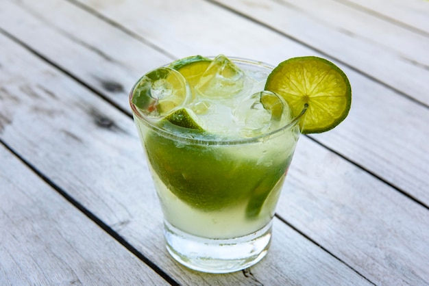 Bebida caipirinha con limón sobre una mesa de madera envejecida Bebida típica brasileña hecha con cachaca