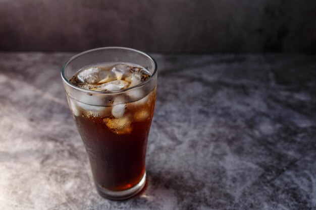 Bebida de cola en un vaso con hielo