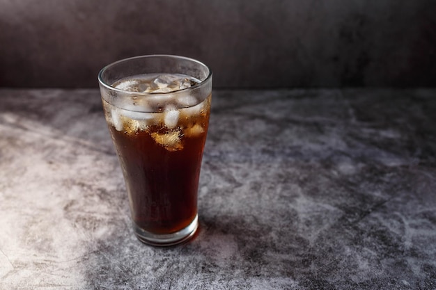 Bebida de cola en un vaso con hielo