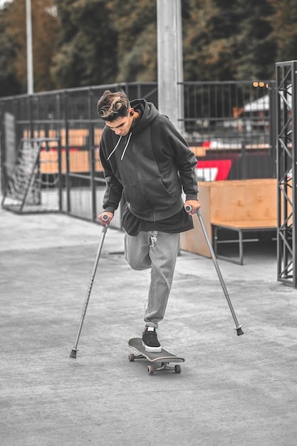 Foto behinderter mann, der im park skateboard fährt