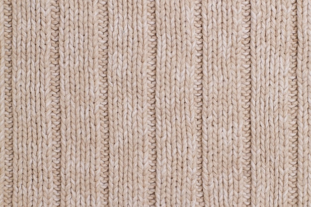 Beige gestrickter abstrakter Hintergrund Textur eines beigen Wollpullovers