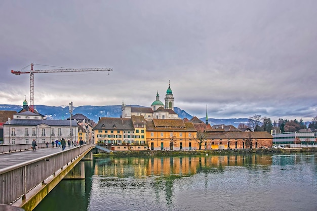 Beira-mar com a Catedral de St Ursus e o Palais Besenval. Solothurn é a capital do cantão de Solothurn, na Suíça. Está localizado nas margens do Aare e no sopé das montanhas Weissenstein Jura