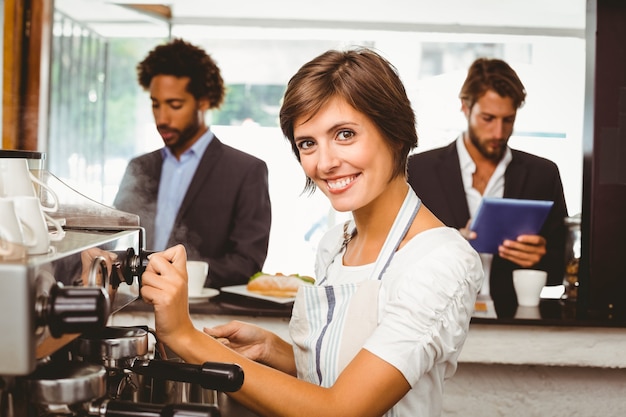 Bela barista fazendo xícara de café