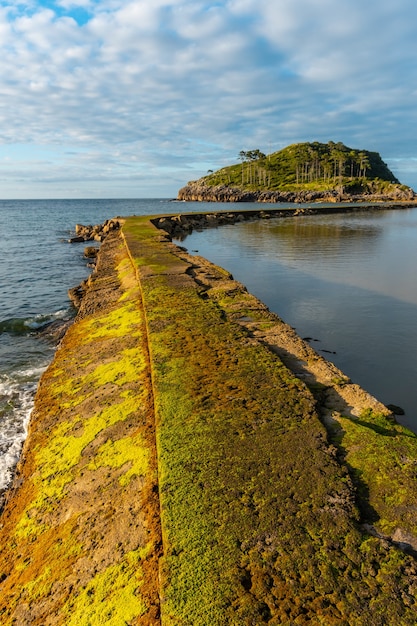 Foto bela estrada para a ilha de san nicolas na maré baixa da praia de isuntza em lekeitio, país basco