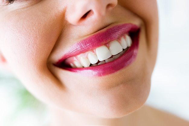 Bela jovem com sorriso perfeito. Isolado no branco.