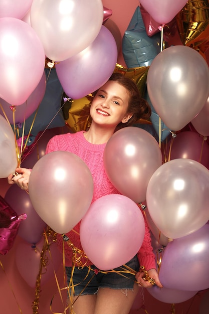 Foto bela jovem ruiva com balões coloridos