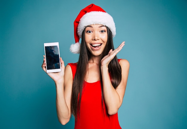 Bela jovem sorridente com chapéu de Papai Noel isolado