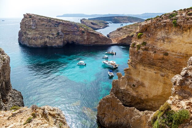 Bela lagoa azul com águas cristalinas turquesa, iates e barcos em um dia ensolarado de verão. Comino, Malta