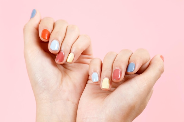 Bela mão feminina pintando unhas de gel acrílico Estilo de moda Fundo rosa