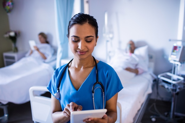 Bela médica usando tablet digital na enfermaria