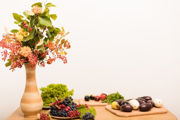 Bela natureza morta de outono de bagas e frutas na mesa da cozinha