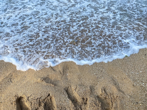 Bela praia de areia e espaço de cópia de fundo de onda de oceano azul suave