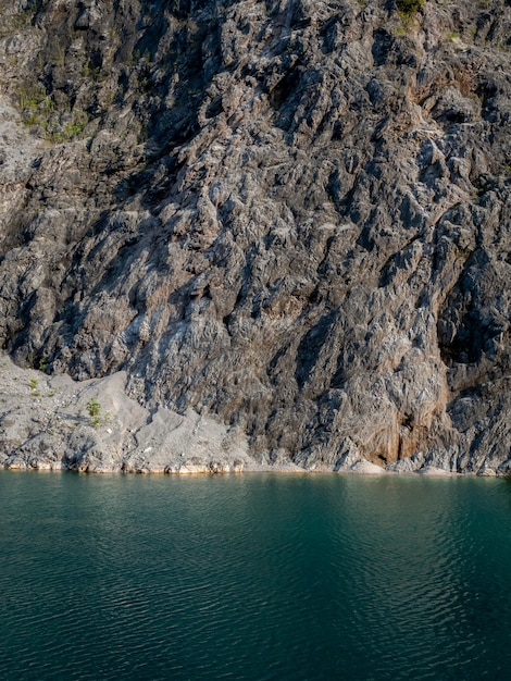 Bela textura de montanha de rocha e fundo de lago de água azul estilo vertical penhasco forte com verde paz água mar paisagem de viagem natural antiga pedreira na província de Phang Nga Tailândia