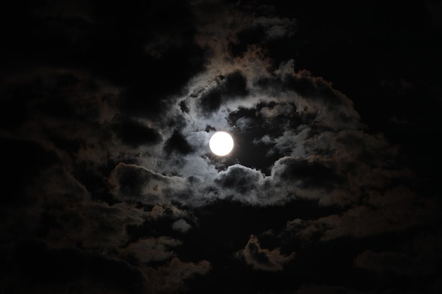 Bela vista da lua cheia e nuvens no céu noturno escuro